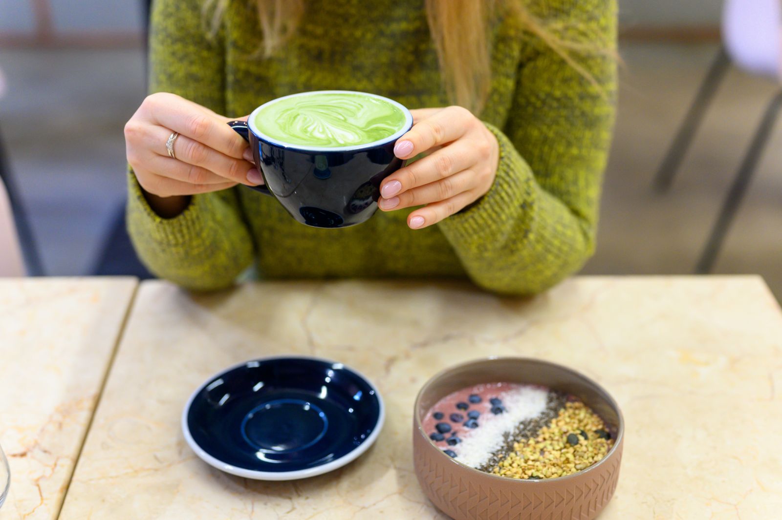 Person holding a Matcha latte