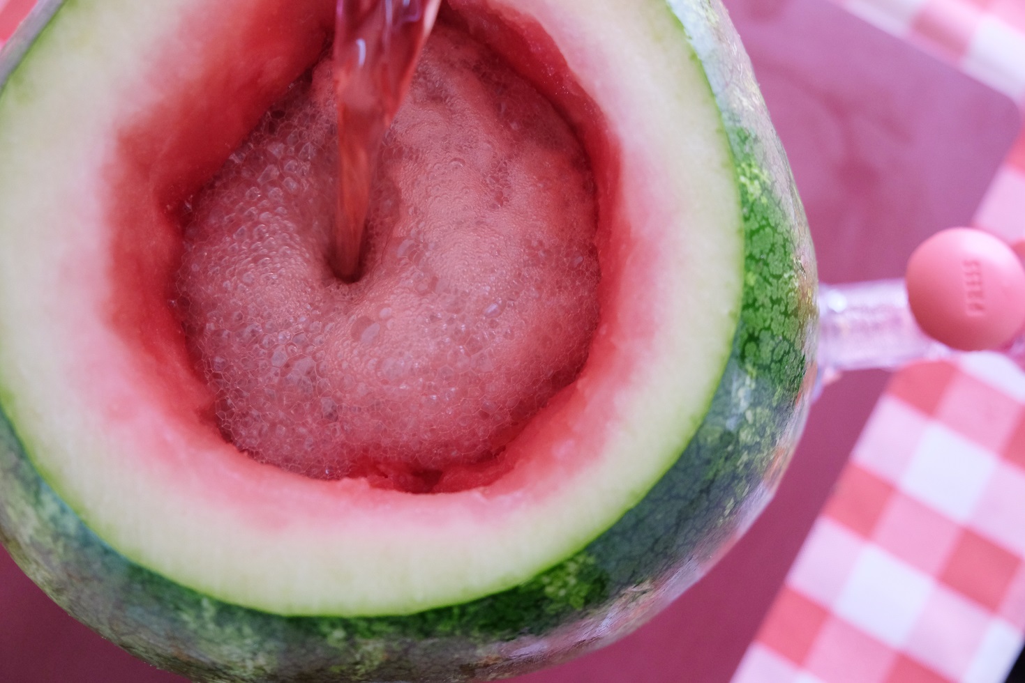 pouring italian soda in watermelon cavity