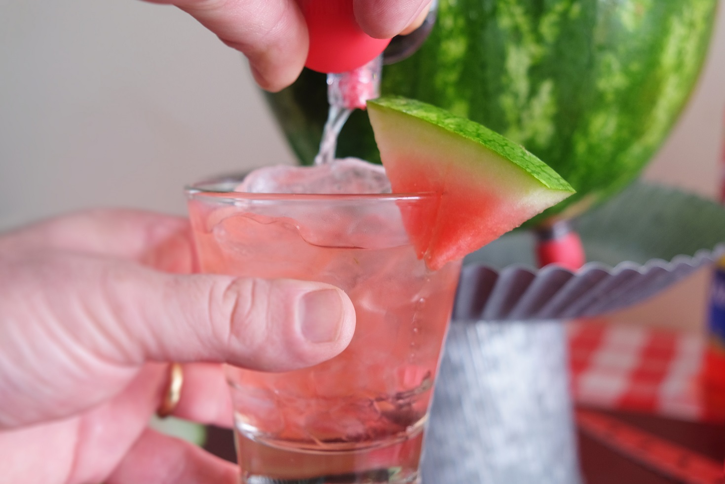 filling glass up from watermelon keg