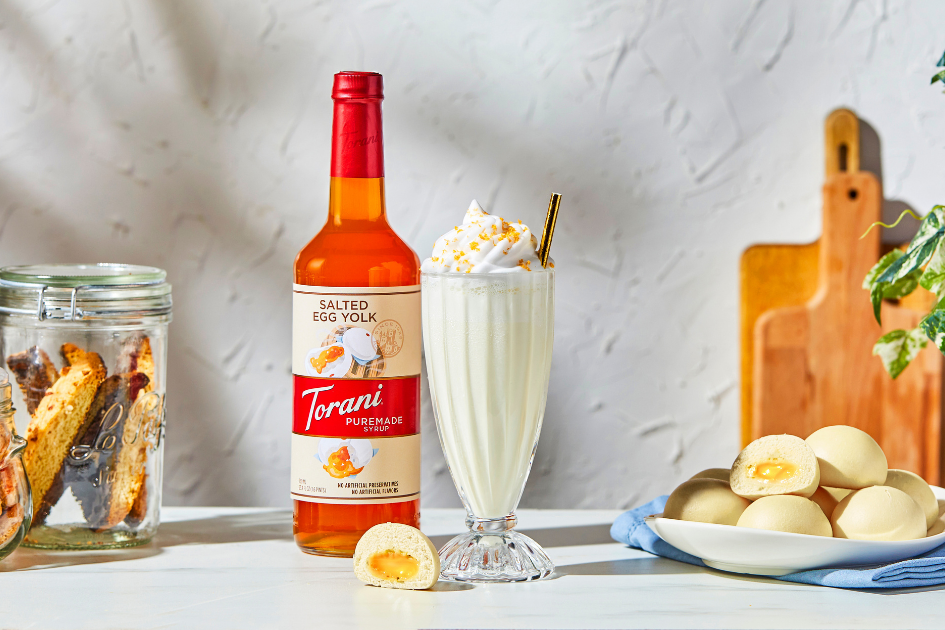 Image of milkshake with bottle of Torani Puremade Salted Egg Yolk Syrup next to it