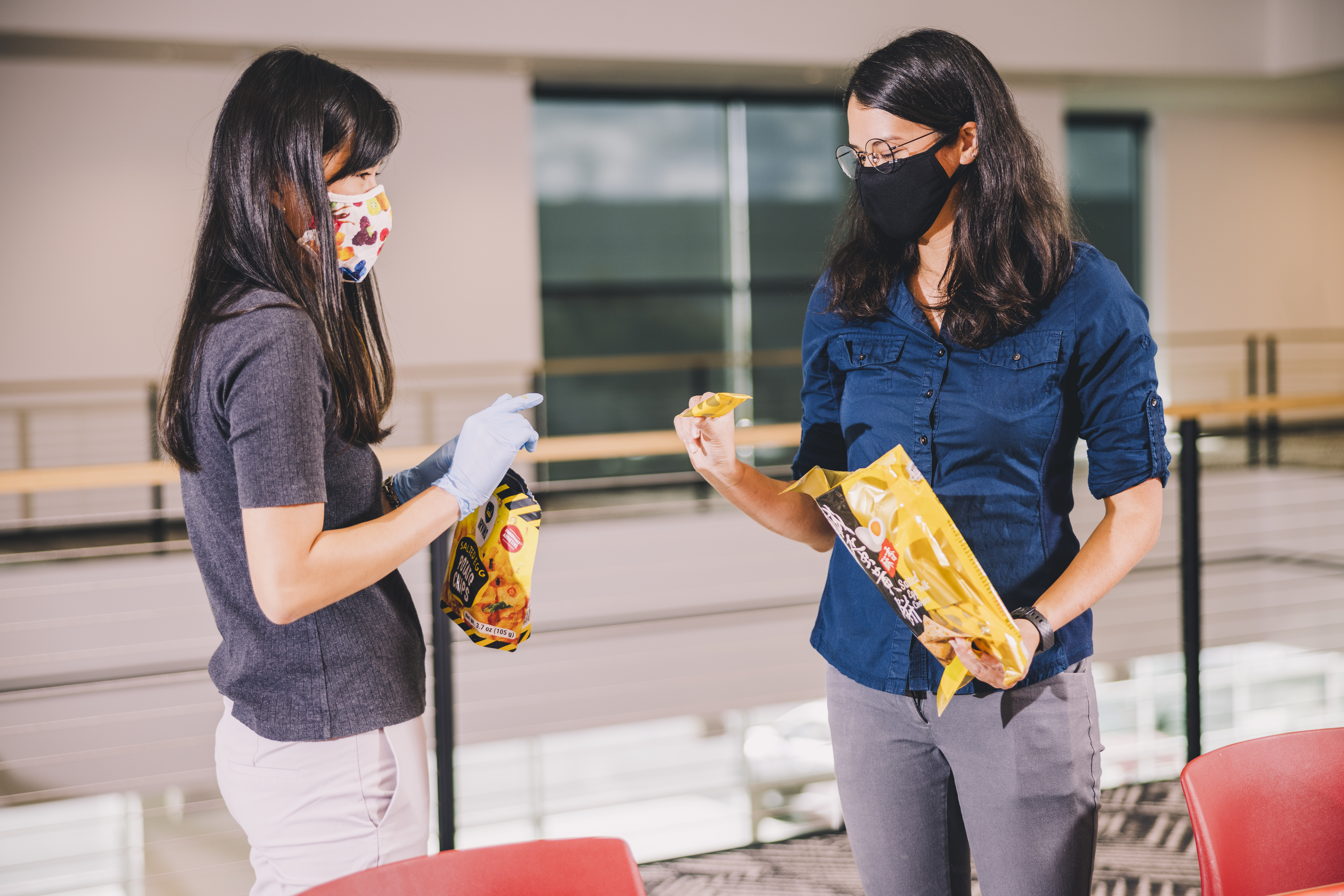 two torani team members opening bags