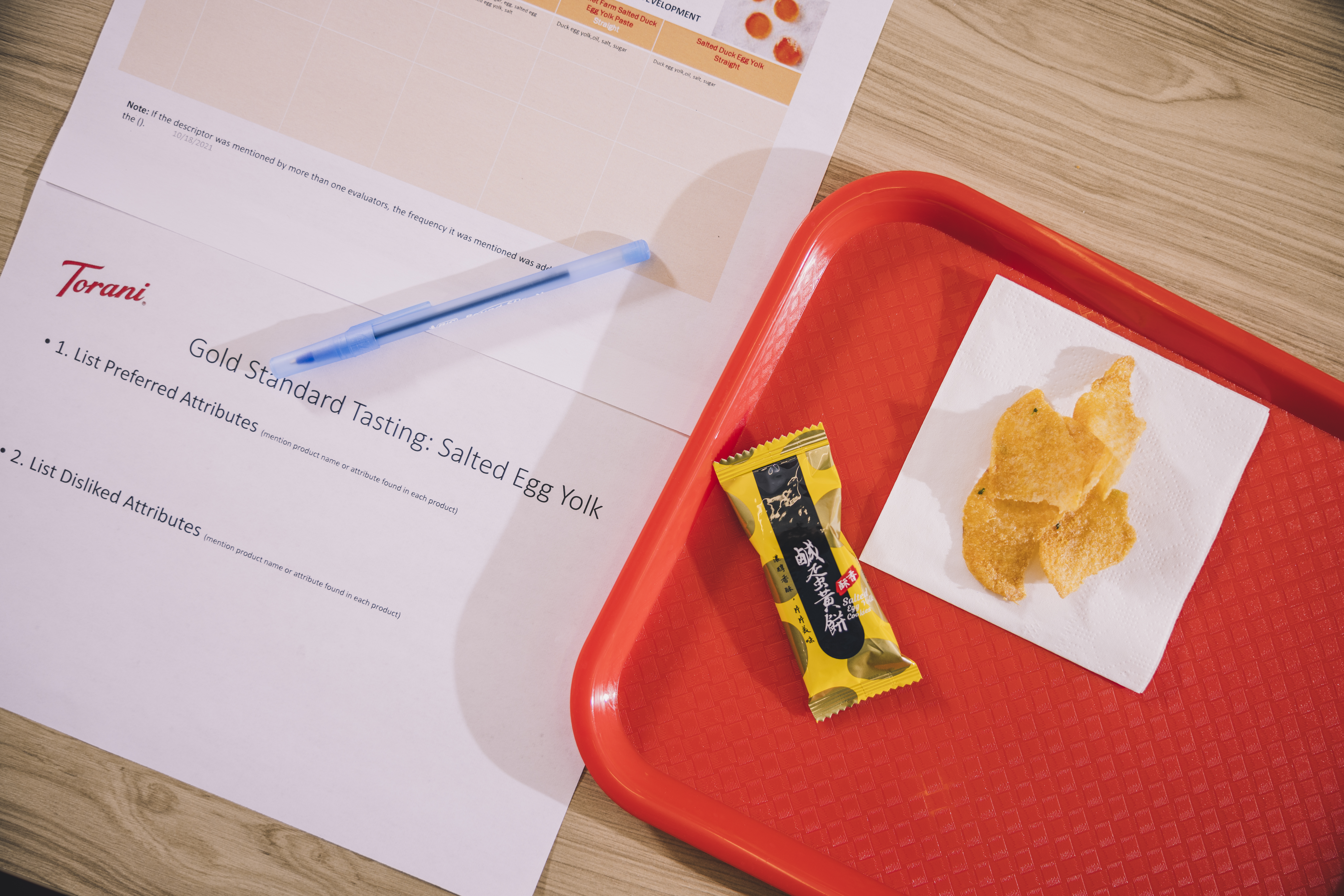 table with gold standard tasting form and some food for tasting